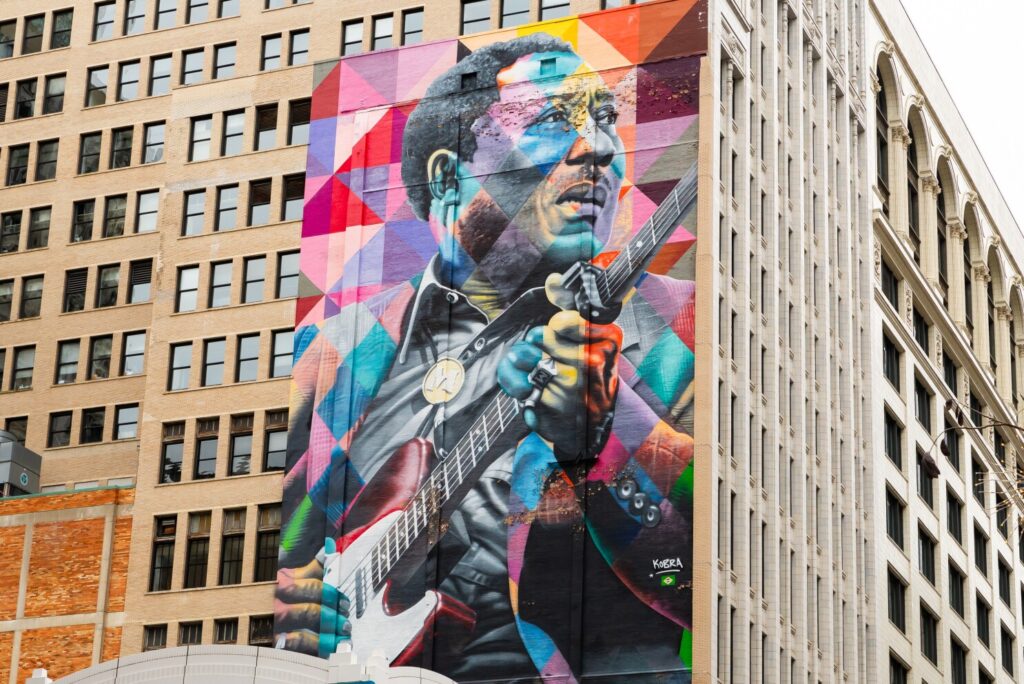 A mural of Chicago blues legend 'Muddy Waters' on the side of a building